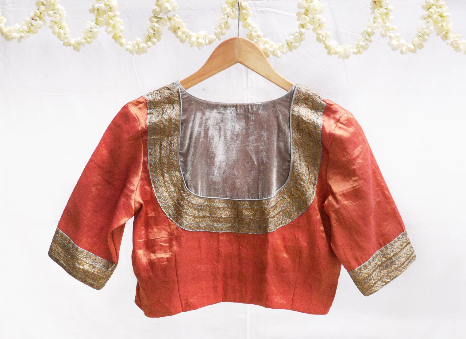 Light grey velvet potli with gold jari embroidery.